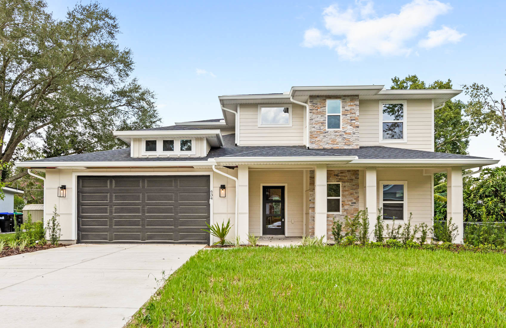 front of two story modern home with brick and light beige paint
